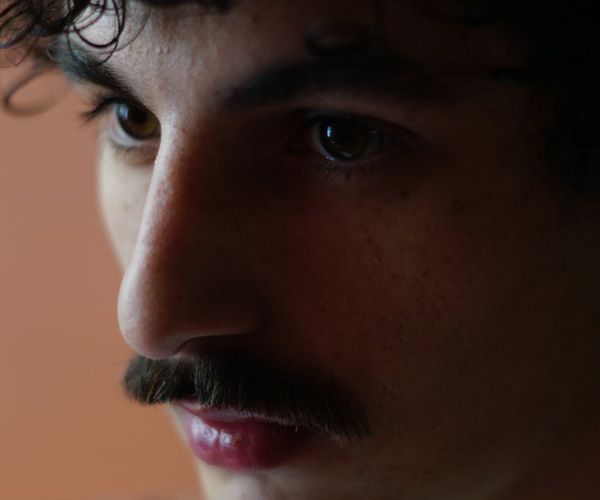Close-up of a person's serene face during a deep breath exercise.